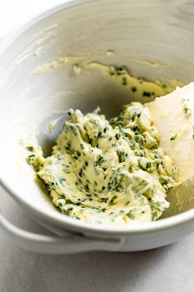Chive butter mixed in bowl.