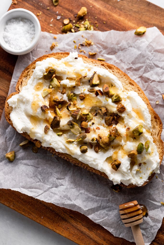 Ricotta toast drizzled with honey and crushed pistachios.