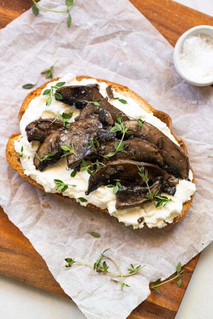 Sauteed mushrooms and fresh thyme on ricotta toast.