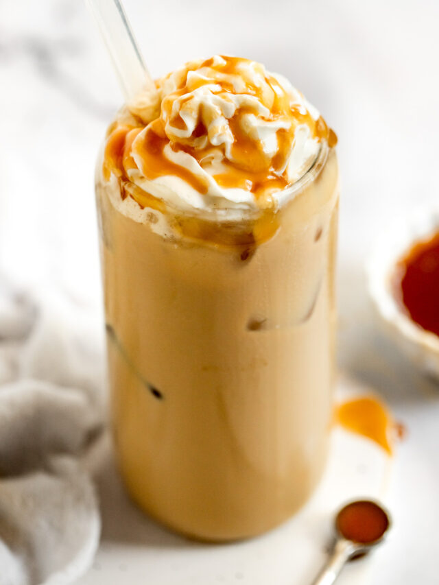 Iced caramel latte with whipped cream and caramel drizzle.