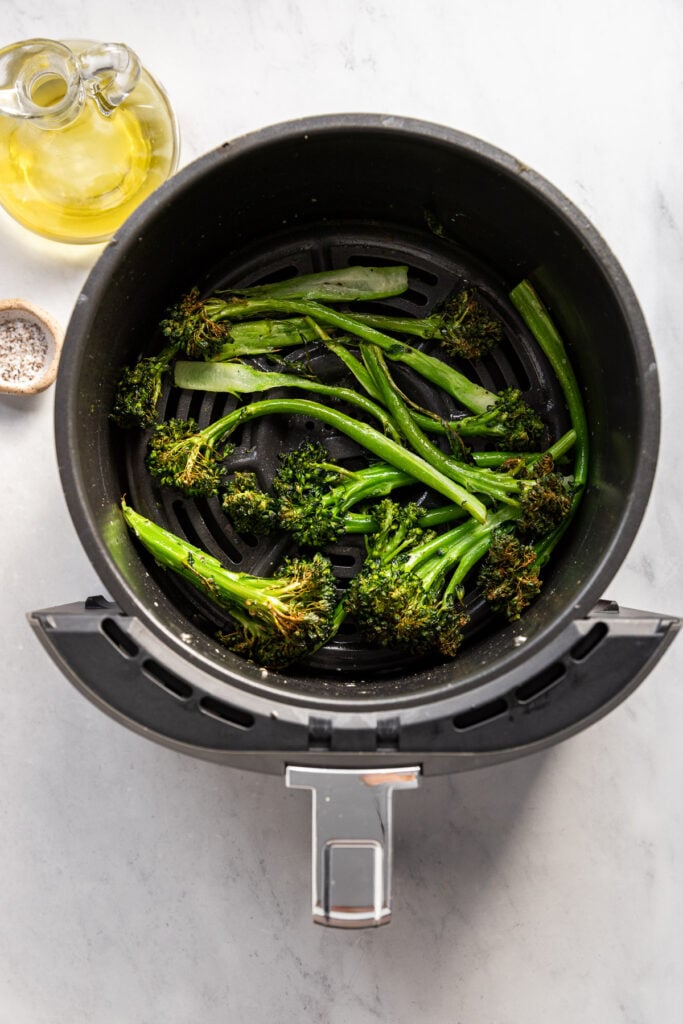 Broccolini in air fryer after cooking.
