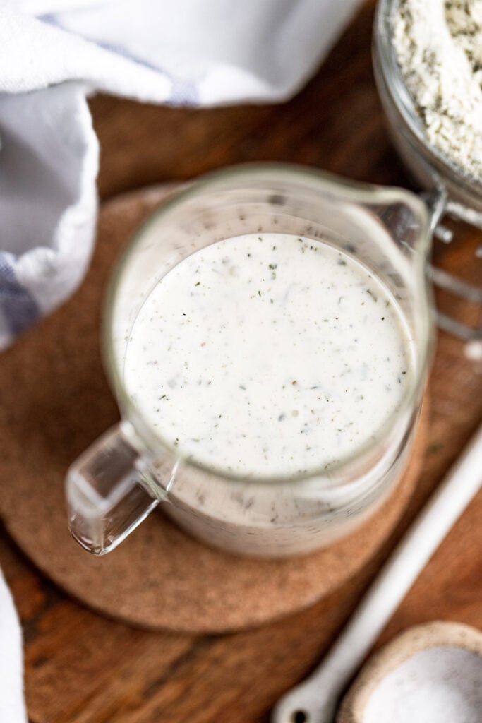 Ranch dressing in glass pitcher.