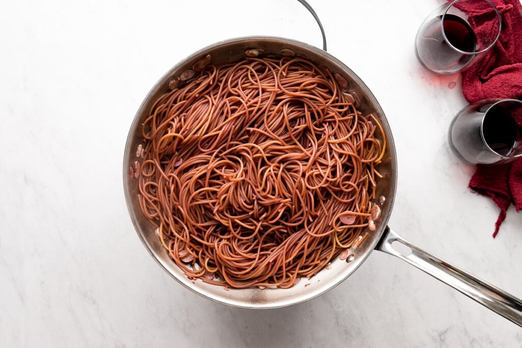Skillet with red wine noodles.