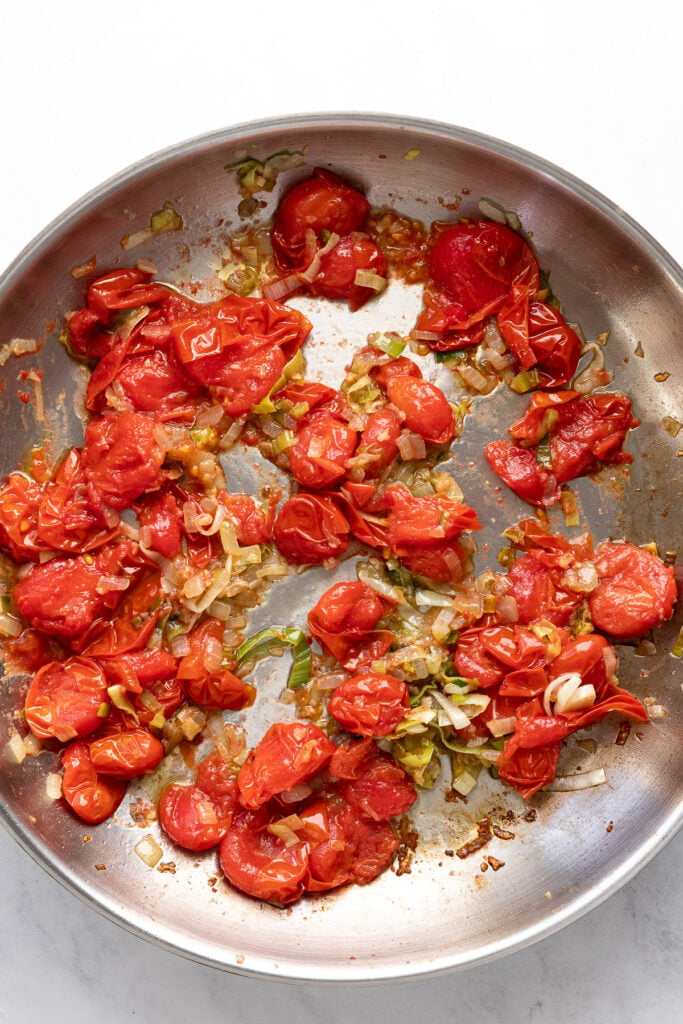 Tomatoes smashed in skillet.