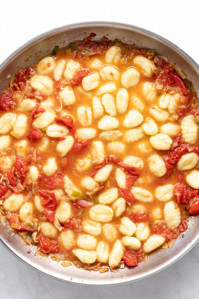 Gnocchi added to pan in layer.