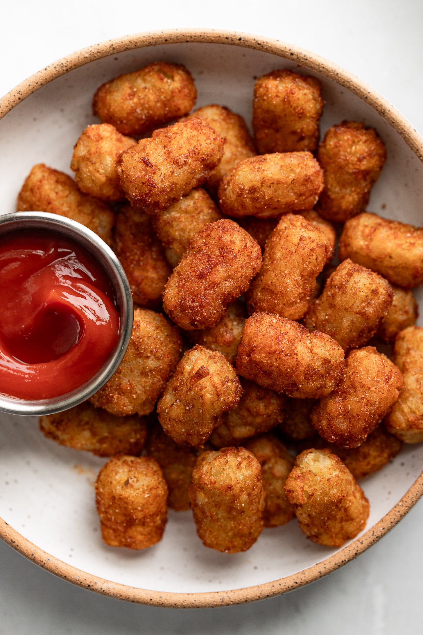 Plate of air fryer tater tots with ketchup.