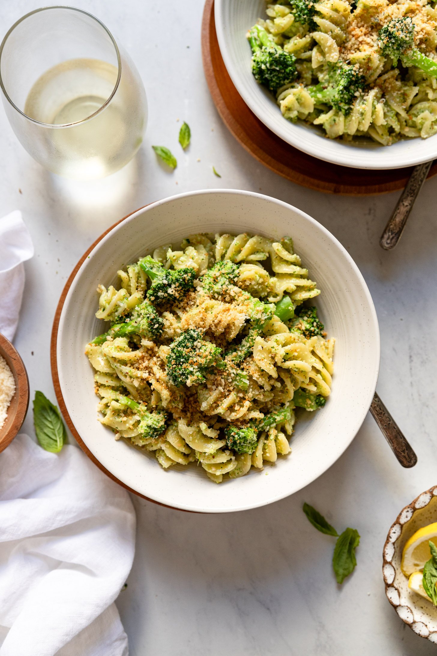 Broccoli Pesto Pasta in bowls next to linen.