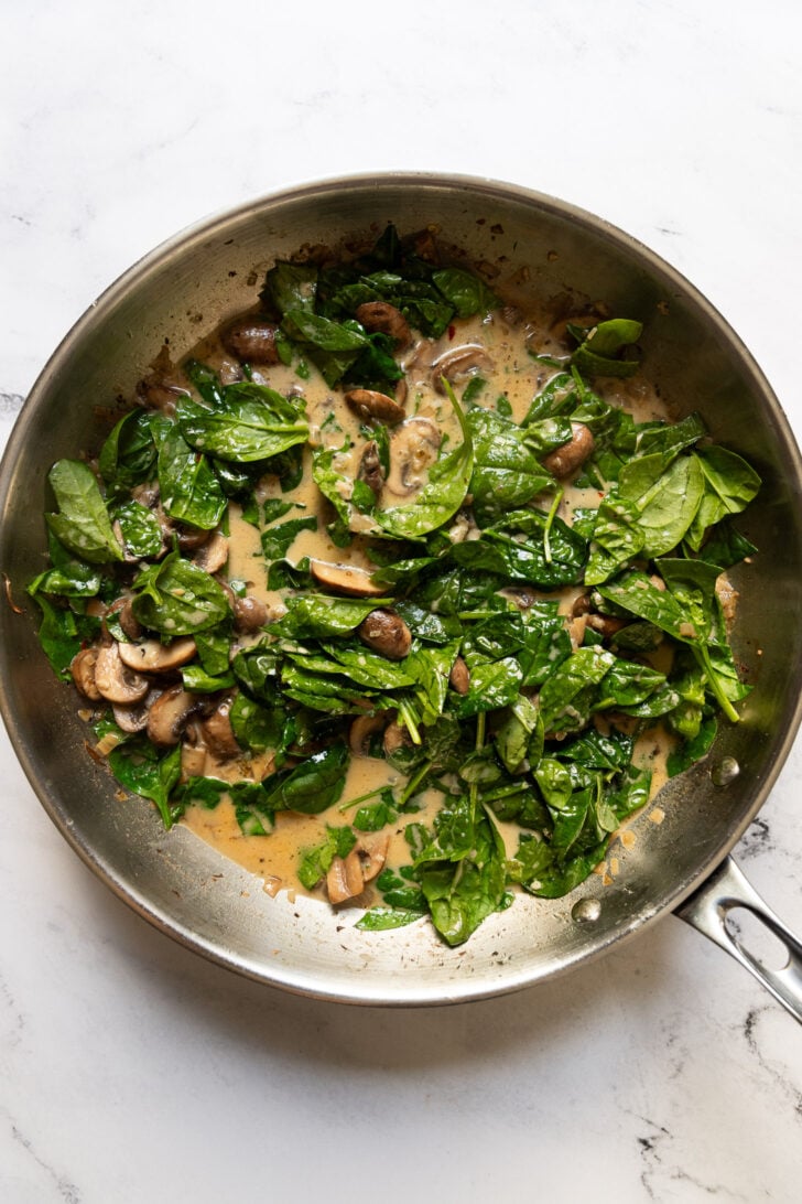 Spinach added to skillet.