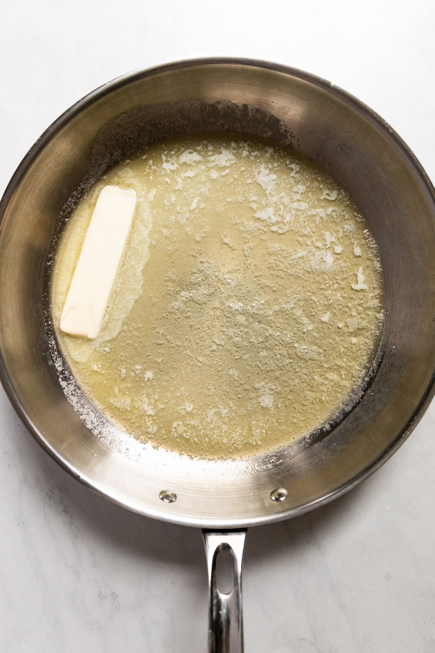 Butter melting in skillet.
