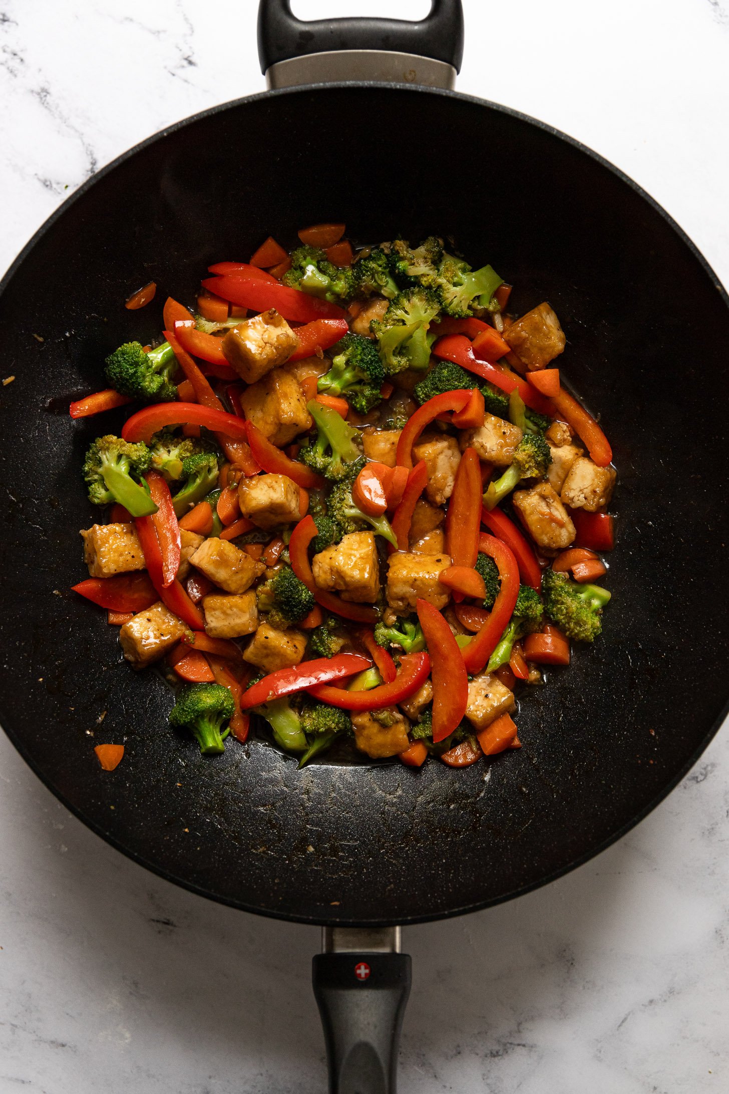 Tofu and sauce into wok with vegetables.