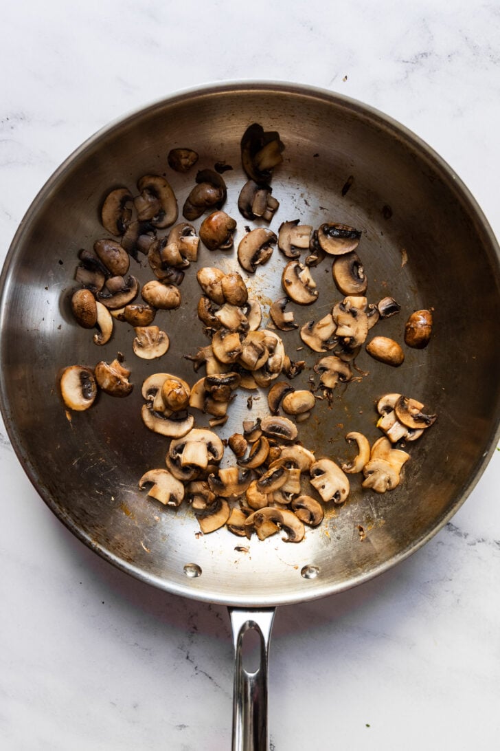 Cooked mushrooms in skillet.