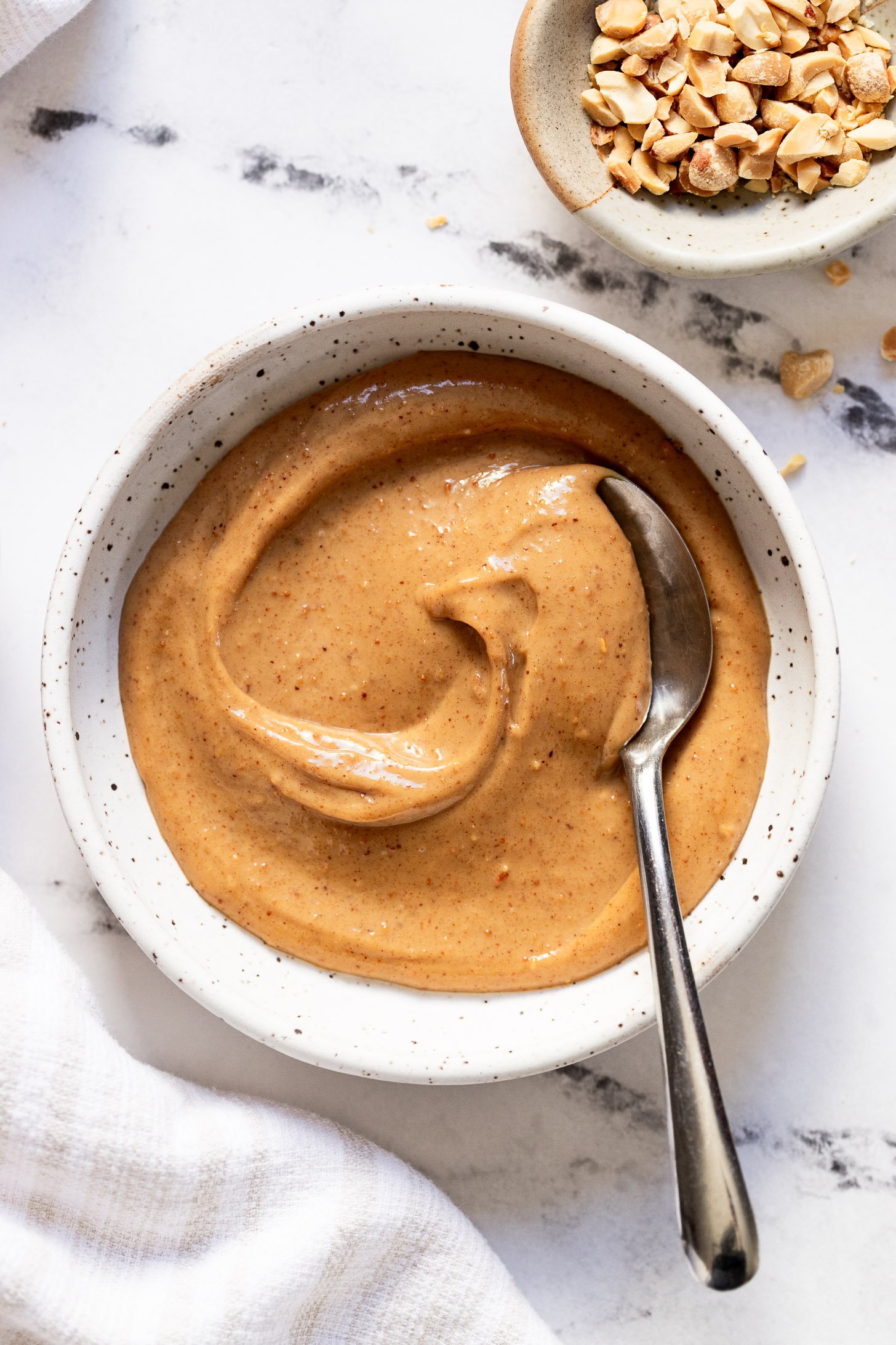 Bowl of peanut butter snack dip with spoon.
