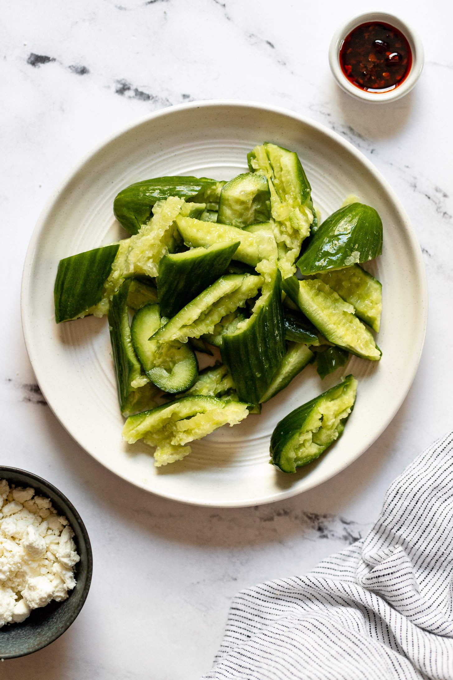Plate of smashed cucumbers.